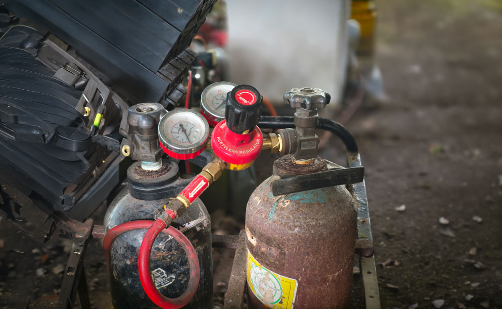 Weathered gas tanks awaiting regulator repair and refurbishment